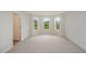 A carpeted bedroom with three bright windows and a walk in closet at 44 Chloe Ct, Selma, NC 27576