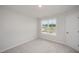 A carpeted bedroom with a bright window at 44 Chloe Ct, Selma, NC 27576