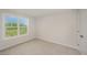 A small bedroom with a large window and carpet at 44 Chloe Ct, Selma, NC 27576