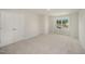 A simple carpeted bedroom featuring a closet and a window at 44 Chloe Ct, Selma, NC 27576