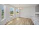 Bright dining space featuring large windows, modern flooring, and neutral color palette at 44 Chloe Ct, Selma, NC 27576