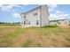 Two-story home with light siding, complemented by a patio and an extensive backyard at 44 Chloe Ct, Selma, NC 27576