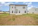 View of the back of the house, showcasing the light siding, patio, and ample backyard space at 44 Chloe Ct, Selma, NC 27576