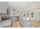 Bright kitchen features stainless appliances, granite counters and island with light wood floors at 44 Chloe Ct, Selma, NC 27576