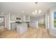 Modern kitchen featuring gray cabinets, granite countertops, an island, and stainless steel appliances at 44 Chloe Ct, Selma, NC 27576