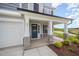 Welcoming front porch with stone pillars and a stylish blue front door with glass inserts at 44 Chloe Ct, Selma, NC 27576