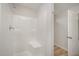 Clean, modern shower with a built in seat, handheld shower head and bright white finish at 44 Chloe Ct, Selma, NC 27576