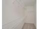 A basic walk-in closet with wire shelving and carpet at 44 Chloe Ct, Selma, NC 27576