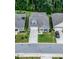 Aerial view of home showcasing its well-manicured lawn, landscaping, and neighborhood setting nestled among mature trees at 440 Bramble Ln, Clayton, NC 27527