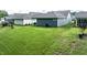 A serene backyard featuring a well-maintained lawn and patio area, great for outdoor entertainment at 440 Bramble Ln, Clayton, NC 27527