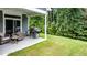 Backyard patio with comfortable seating and grill, perfect for enjoying the green surroundings and outdoor cooking at 440 Bramble Ln, Clayton, NC 27527