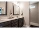 Bathroom showcasing a double vanity and tiled walk-in shower at 440 Bramble Ln, Clayton, NC 27527