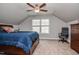 Comfortable bedroom features plush carpet, a ceiling fan, natural light from the window, and neutral color palette at 440 Bramble Ln, Clayton, NC 27527