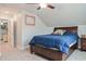 Cozy bedroom with plush carpet, ceiling fan, and a comfortable bed with a blue duvet and matching decor at 440 Bramble Ln, Clayton, NC 27527