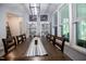 Inviting dining room with a long wooden table, decorative cabinets, and large windows at 440 Bramble Ln, Clayton, NC 27527