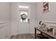Welcoming entryway with wainscoting, a stylish console table, and a clear view of the front door at 440 Bramble Ln, Clayton, NC 27527