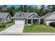 Beautiful single-story home features a manicured lawn, brick accents, a two-car garage, and an inviting front porch at 440 Bramble Ln, Clayton, NC 27527