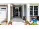 Inviting front porch features stone accents, comfortable seating, and a welcoming entrance to this charming home at 440 Bramble Ln, Clayton, NC 27527