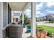 Charming front porch with comfortable seating, decorative planters, and views of the landscaped yard and peaceful street at 440 Bramble Ln, Clayton, NC 27527