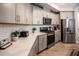 Modern kitchen features sleek gray cabinetry, stainless steel appliances, and quartz countertops, offering a stylish and functional space at 440 Bramble Ln, Clayton, NC 27527