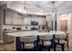 Stylish kitchen featuring a large island with seating, modern pendant lighting, and stainless steel appliances for culinary enthusiasts at 440 Bramble Ln, Clayton, NC 27527