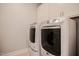 Modern laundry room with white cabinets and front-loading washer and dryer for convenient chores at 440 Bramble Ln, Clayton, NC 27527