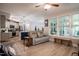 Cozy living room featuring comfortable seating, hardwood floors, and lots of natural light at 440 Bramble Ln, Clayton, NC 27527