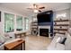 Bright and airy living room with a fireplace, built-in shelves, and large windows at 440 Bramble Ln, Clayton, NC 27527