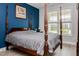 A primary bedroom with a four-poster bed, and light-filled window at 440 Bramble Ln, Clayton, NC 27527