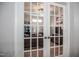Home office with a desk and shelves, as seen through glass paneled doors at 440 Bramble Ln, Clayton, NC 27527