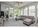 Bright screened-in patio with generous seating, neutral color palette, and serene view of the outdoors at 440 Bramble Ln, Clayton, NC 27527