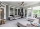 Inviting screened-in patio with ample seating, ceiling fan, and plenty of natural light for relaxing and entertaining at 440 Bramble Ln, Clayton, NC 27527