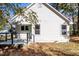 Side angle of a white home featuring new windows and a charming covered porch at 460 Dickens Dr, Raleigh, NC 27610