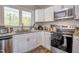 Modern kitchen with white cabinets, stainless steel appliances, and plenty of counter space at 460 Dickens Dr, Raleigh, NC 27610