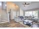 Bright living room with a fireplace, a large sectional couch, and access to a staircase at 460 Dickens Dr, Raleigh, NC 27610