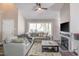Cozy living room featuring fireplace, a large sectional couch, and ample natural light at 460 Dickens Dr, Raleigh, NC 27610