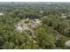 Aerial view of a neighborhood surrounded by lush trees with a cityscape visible on the horizon at 4812 Latimer Rd, Raleigh, NC 27609