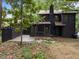 Backyard featuring a screened in porch, wood deck, mature landscaping and a charcoal grey facade at 4812 Latimer Rd, Raleigh, NC 27609