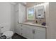 Bathroom with stylish vanity, modern black fixtures, sleek mirror, and an abundance of storage space at 4812 Latimer Rd, Raleigh, NC 27609