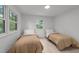 Inviting bedroom with twin beds, light walls, and bright windows offering pleasant views at 4812 Latimer Rd, Raleigh, NC 27609