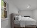 Modern bedroom featuring hardwood floors and a corduroy bed frame and an abundance of natural light at 4812 Latimer Rd, Raleigh, NC 27609