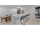 Open-concept design featuring a stylish breakfast bar with seating and dining table near an outdoor entryway at 4812 Latimer Rd, Raleigh, NC 27609