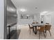 Bright dining room featuring a sleek fireplace, modern dining set, and open access to the kitchen at 4812 Latimer Rd, Raleigh, NC 27609