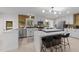 Bright kitchen featuring white cabinets, stainless steel appliances, a large island, and decorative backsplash at 4812 Latimer Rd, Raleigh, NC 27609