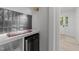 Convenient wet bar with a wine cooler, counter space, shelving, and attractive tile backsplash at 4812 Latimer Rd, Raleigh, NC 27609