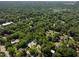An aerial view of a neighborhood nestled in lush green trees at 508 N Wake St, Hillsborough, NC 27278