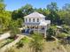 Expansive two-story house with a large porch surrounded by lush landscaping and trees at 508 N Wake St, Hillsborough, NC 27278