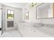 Bright bathroom featuring double sinks with marble countertops and herringbone tile floors at 508 N Wake St, Hillsborough, NC 27278
