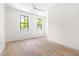 Bedroom with two windows, hardwood floors, and a ceiling fan at 508 N Wake St, Hillsborough, NC 27278