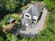 An aerial view reveals this home's garage, driveway, and garden space with a shed and leafy surroundings at 508 N Wake St, Hillsborough, NC 27278